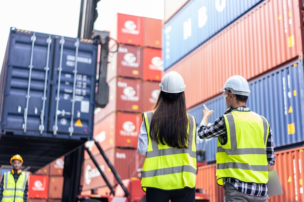 Caucasian,Business,Man,And,Woman,Worker,Working,In,Container,Terminal.